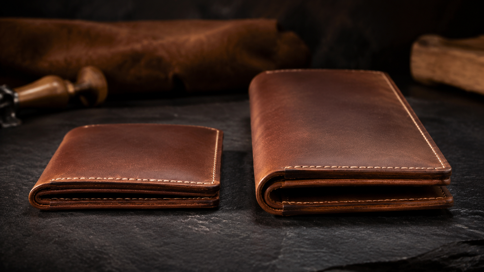 Side by side comparison of slim bifold wallet and long leather wallet on dark slate